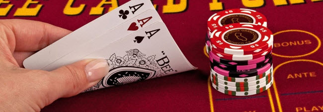 player playing 3 card poker in the East Bay Casino and holding a hand of 3 aces